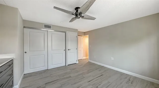 a view of an empty room with a ceiling fan
