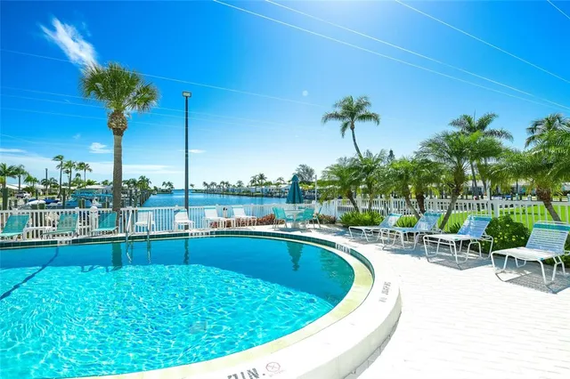 a view of a swimming pool with a table and chairs