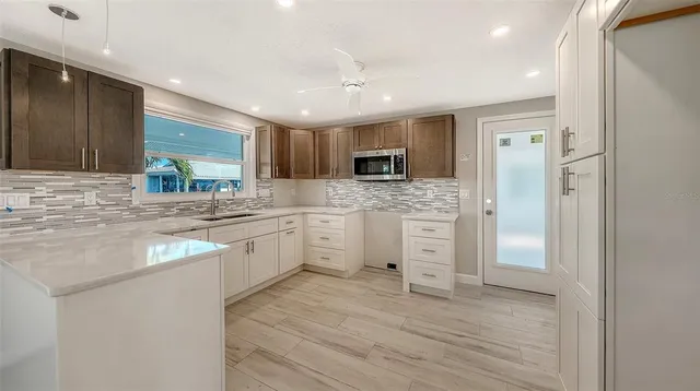 a kitchen with a refrigerator stove and sink
