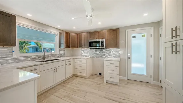 a large kitchen with cabinets and stainless steel appliances