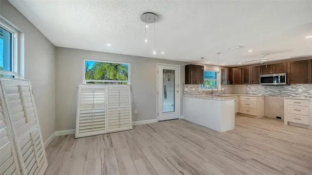 a view of kitchen with sink and wooden floor