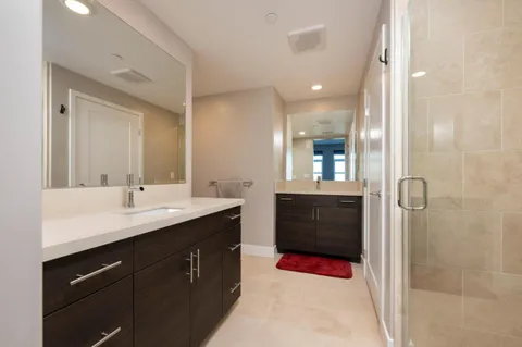 a bathroom with a sink double vanity and a mirror