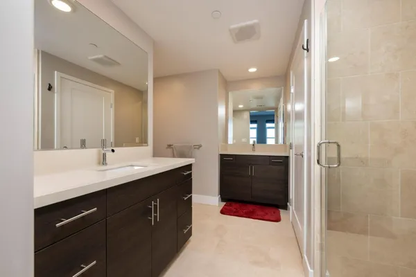 a bathroom with a sink double vanity and a mirror