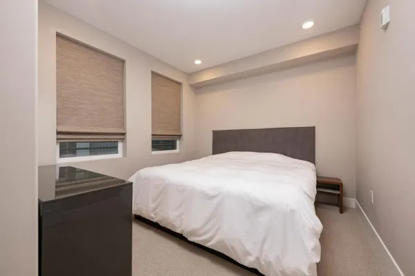 a bedroom with a bed and cabinet