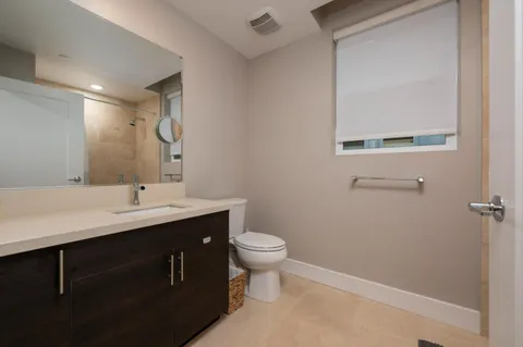 a bathroom with a sink toilet and a mirror