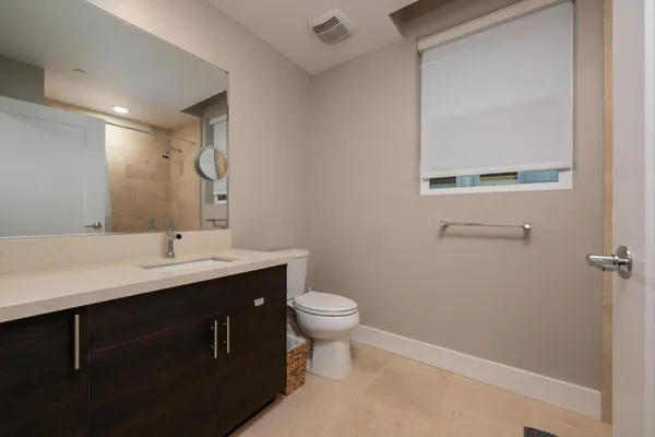 a bathroom with a sink toilet and a mirror