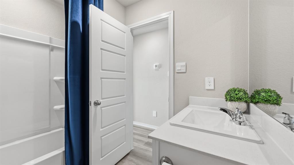 16428 Hudson Pr Way Justin, TX 76247 - Photo 27 of 39 a bathroom with a granite countertop sink and a mirror