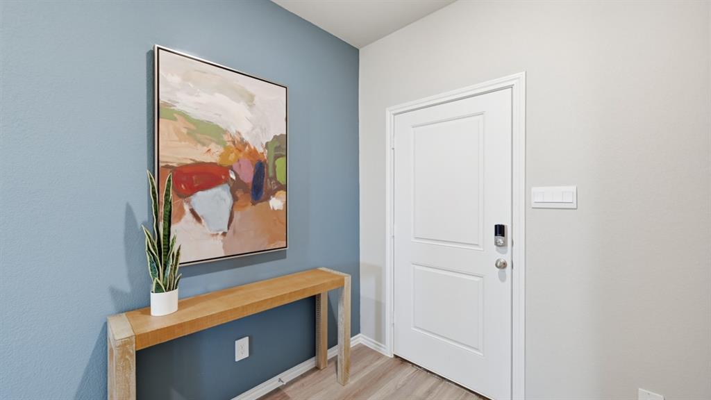 16428 Hudson Pr Way Justin, TX 76247 - Photo 32 of 39 a room with wooden floor and painting on the wall