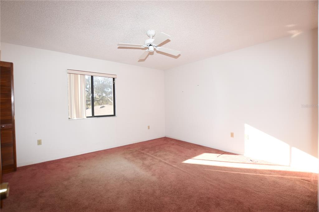 707 Carpenters Way, Unit 45 Lakeland, FL 33809 - Photo 12 of 20 an empty room with windows and ceiling fan view