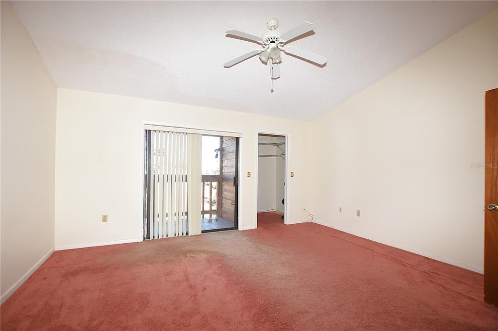 707 Carpenters Way, Unit 45 Lakeland, FL 33809 - Photo 16 of 20 an empty room with chandelier fan and windows