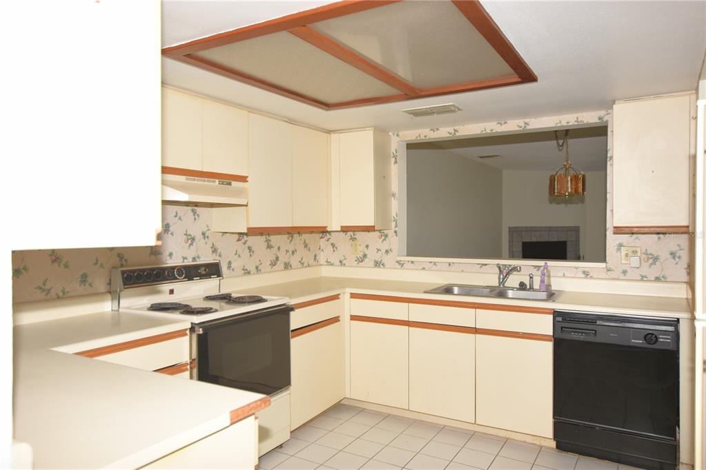 707 Carpenters Way, Unit 45 Lakeland, FL 33809 - Photo 7 of 20 a kitchen with stainless steel appliances granite countertop a sink and cabinets