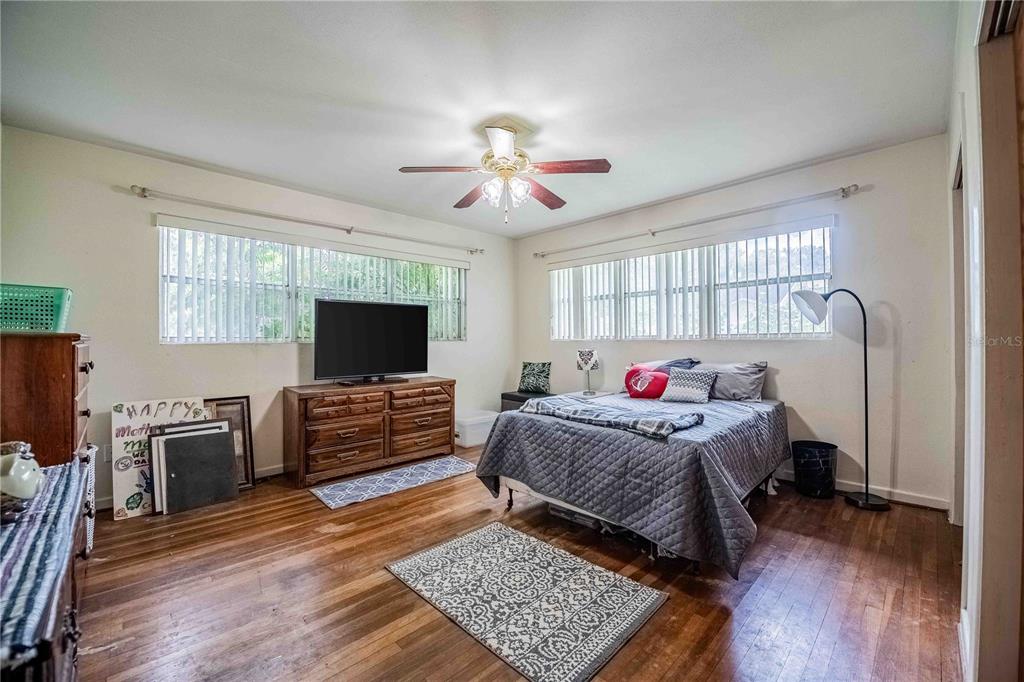 5110 Lakeland Highlands Road Lakeland, FL 33813 - Photo 13 of 40 a bedroom with a bed and flat screen tv