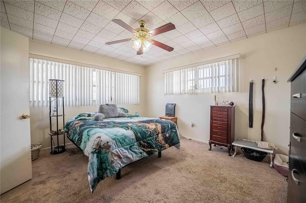 5110 Lakeland Highlands Road Lakeland, FL 33813 - Photo 16 of 40 a bed sitting in a room next to a window