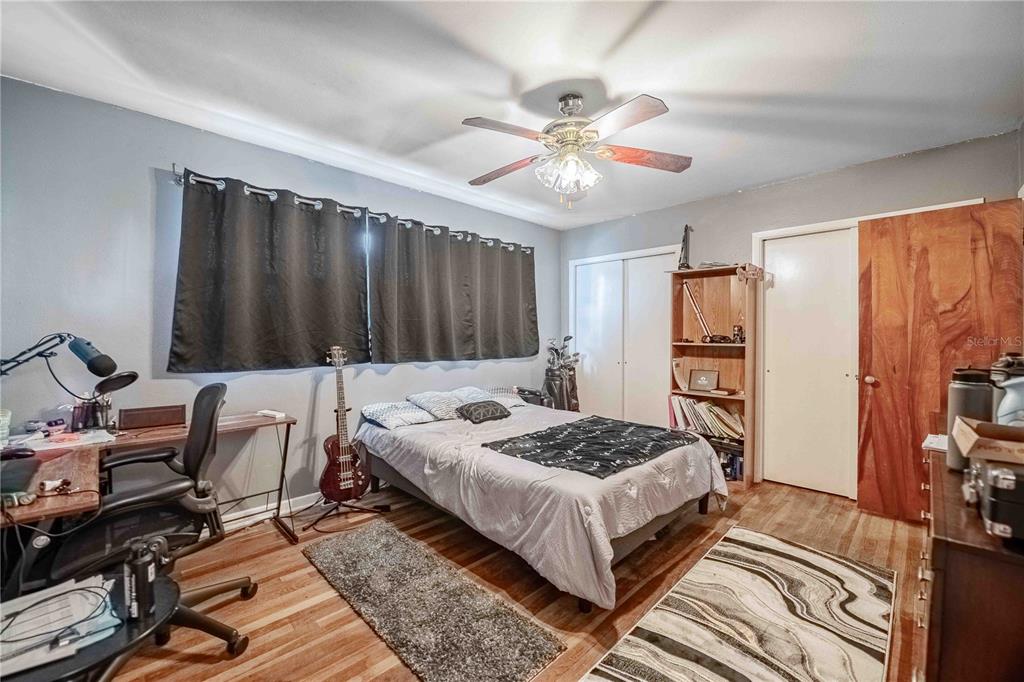 5110 Lakeland Highlands Road Lakeland, FL 33813 - Photo 20 of 40 a bedroom with a bed and a chandelier