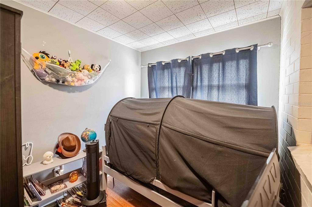 5110 Lakeland Highlands Road Lakeland, FL 33813 - Photo 23 of 40 a bedroom with a bed and a painting on the wall