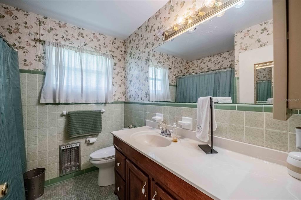 5110 Lakeland Highlands Road Lakeland, FL 33813 - Photo 24 of 40 a bathroom with a sink a toilet and mirror