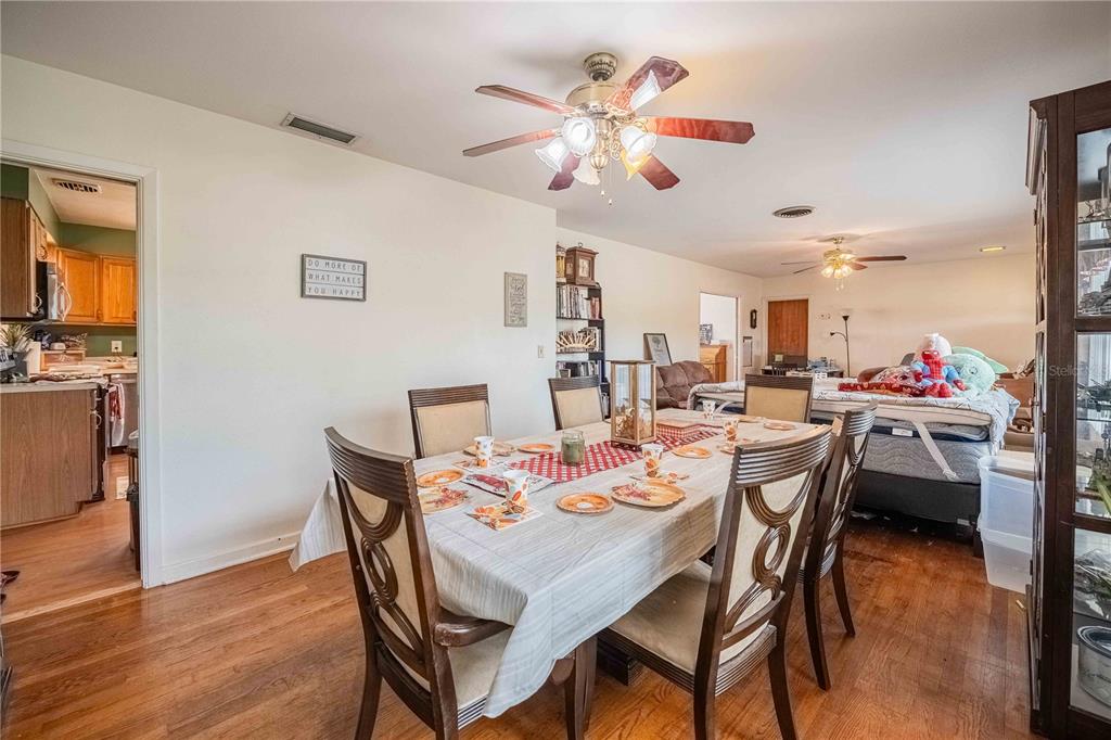 5110 Lakeland Highlands Road Lakeland, FL 33813 - Photo 26 of 40 a dining room with furniture a chandelier and wooden floor