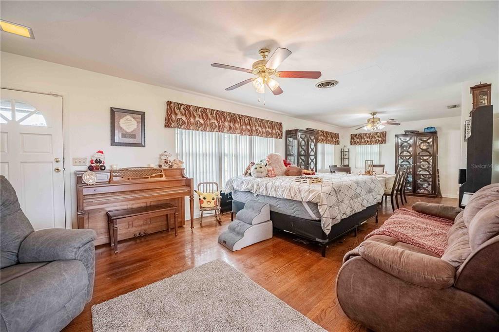 5110 Lakeland Highlands Road Lakeland, FL 33813 - Photo 28 of 40 a bedroom with a bed and wooden floor