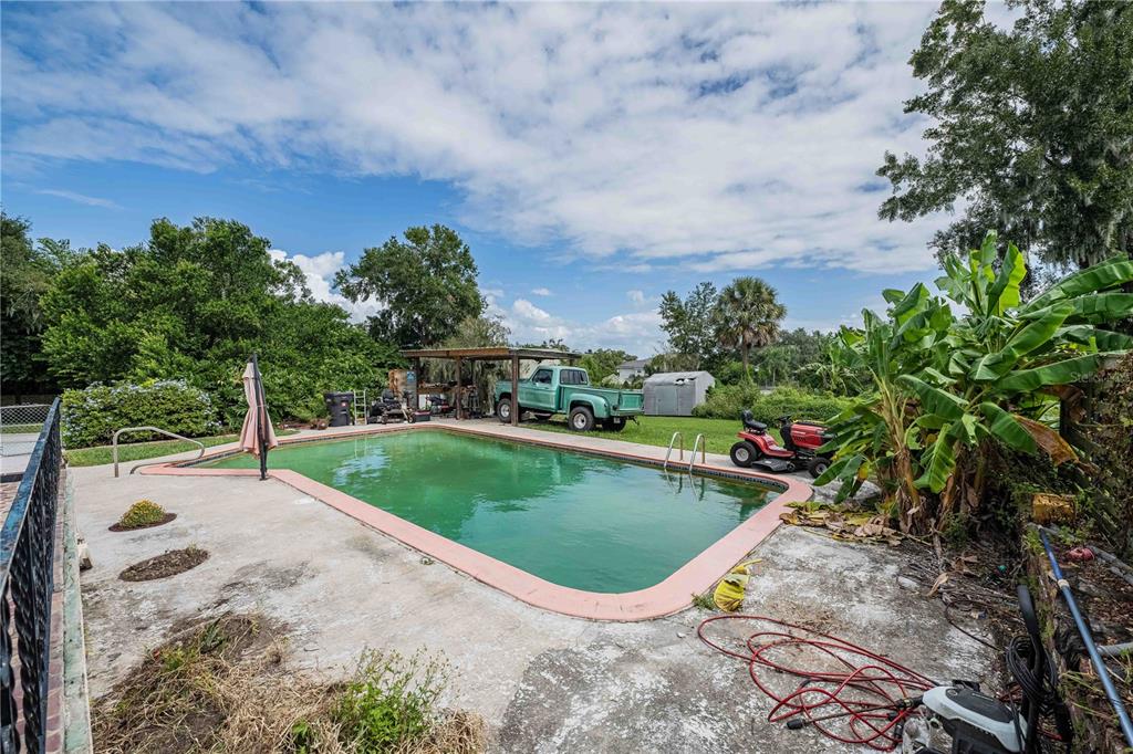 5110 Lakeland Highlands Road Lakeland, FL 33813 - Photo 34 of 40 a view of a swimming pool with a yard