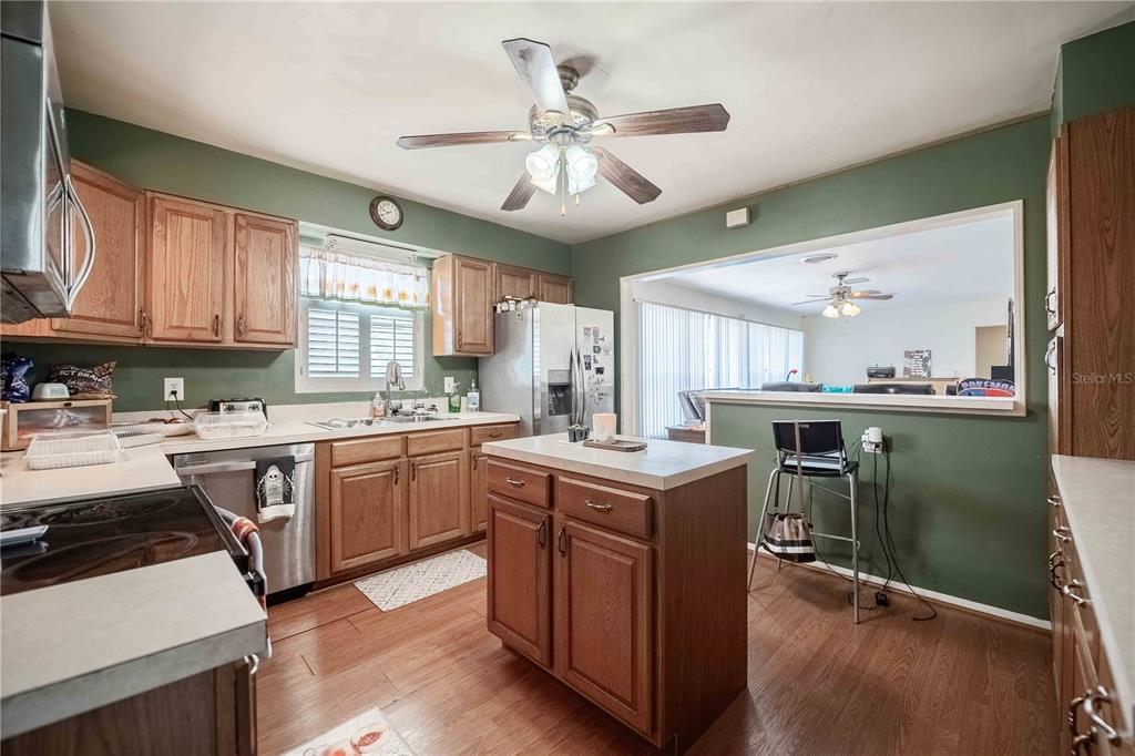 5110 Lakeland Highlands Road Lakeland, FL 33813 - Photo 8 of 40 a kitchen with a stove a sink a dining table and chairs
