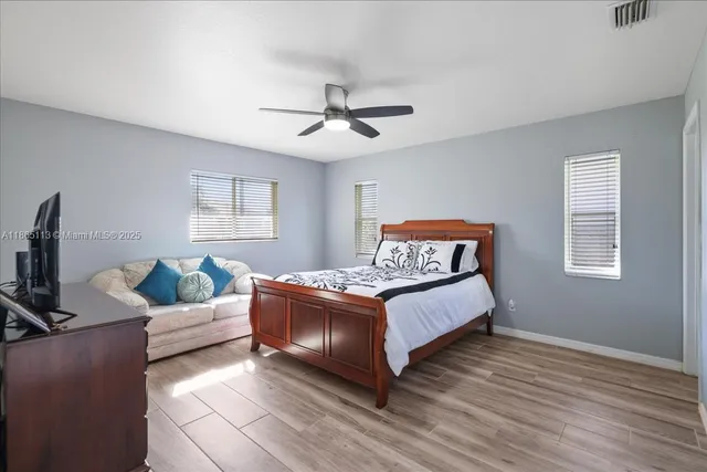 a bedroom with a large bed and a window