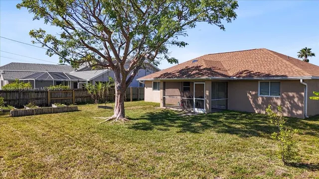 a view of a house with a yard and tree s