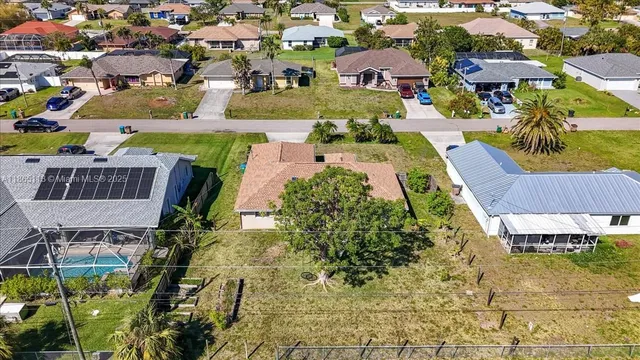 an aerial view of a house with swimming pool and outdoor space