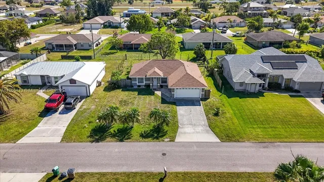 an aerial view of multiple houses with yard