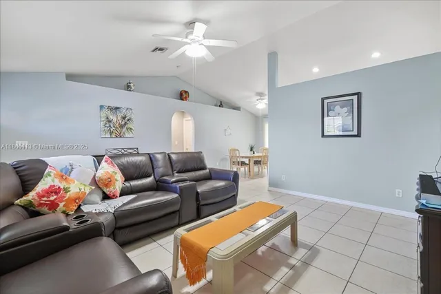 a living room with furniture and a ceiling fan