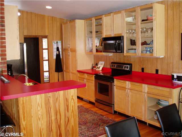 8712 Old Spring Road Richmond, VA 23235 - Photo 4 of 12 a kitchen that has a stove and a microwave