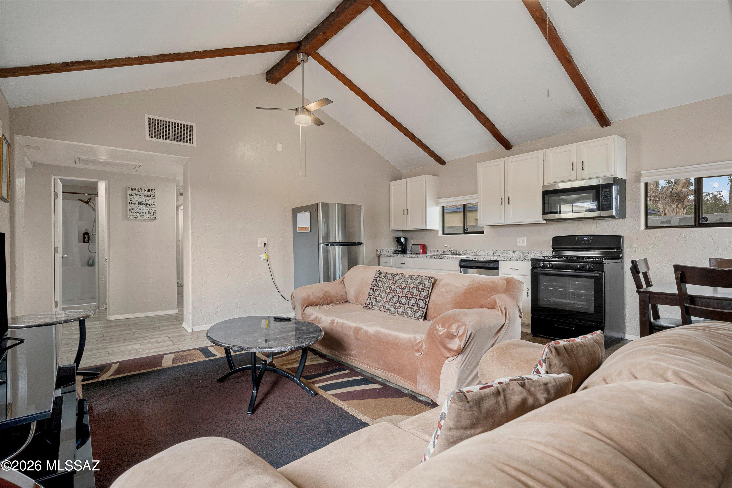 2841 North Richey Boulevard Tucson, AZ 85716 - Photo 9 of 30 a living room with furniture kitchen view and a fireplace