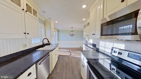 a kitchen with stainless steel appliances a sink stove and cabinets