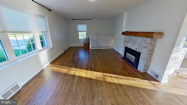 wooden floor in an empty room with a fireplace
