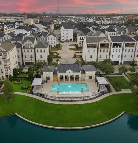 an aerial view of a house with a garden and lake view