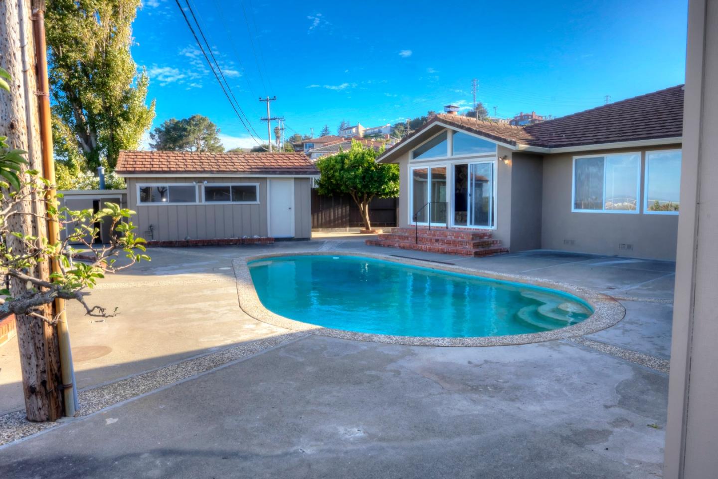 940 Ahwahnee Drive Millbrae, CA 94030 - Photo 19 of 29 a view of a house with a swimming pool and a yard