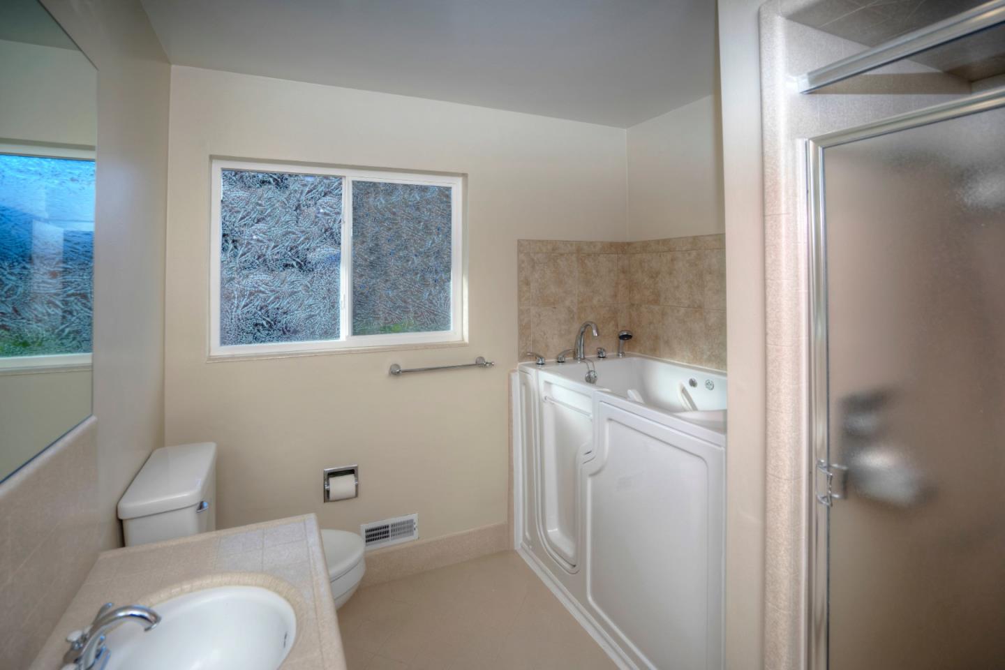 940 Ahwahnee Drive Millbrae, CA 94030 - Photo 6 of 29 a bathroom with a toilet sink and mirror