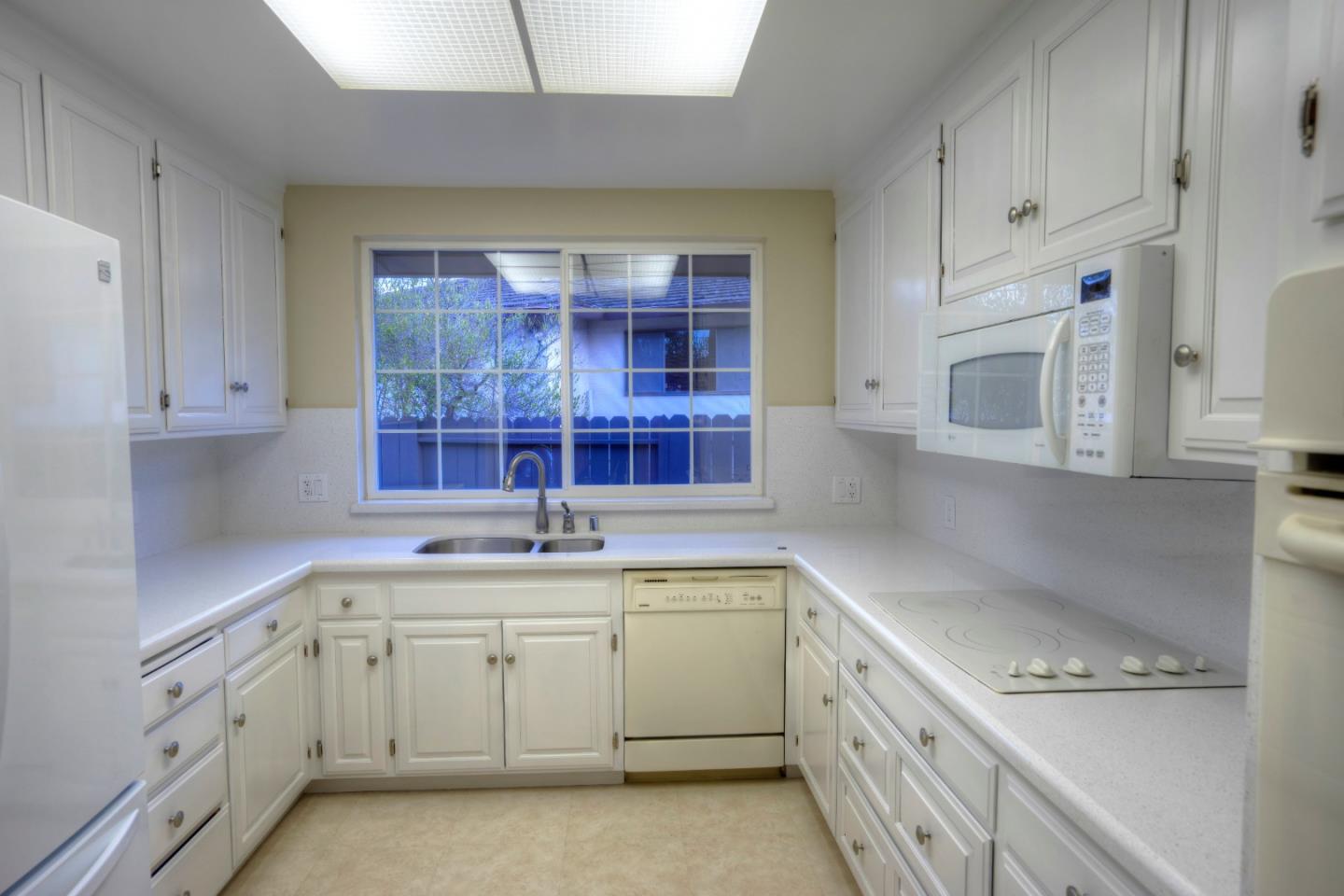 940 Ahwahnee Drive Millbrae, CA 94030 - Photo 9 of 29 a kitchen with a sink stove and cabinets
