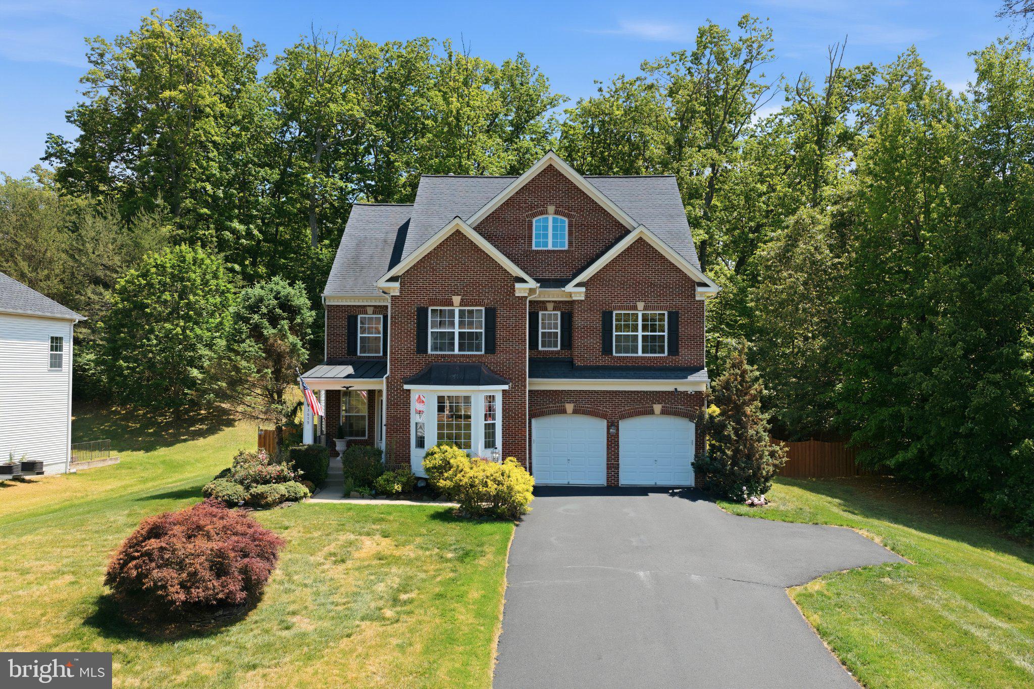 3679 Expedition Drive Triangle, VA 22172 - Photo 1 of 65 a front view of a house with a yard and garage