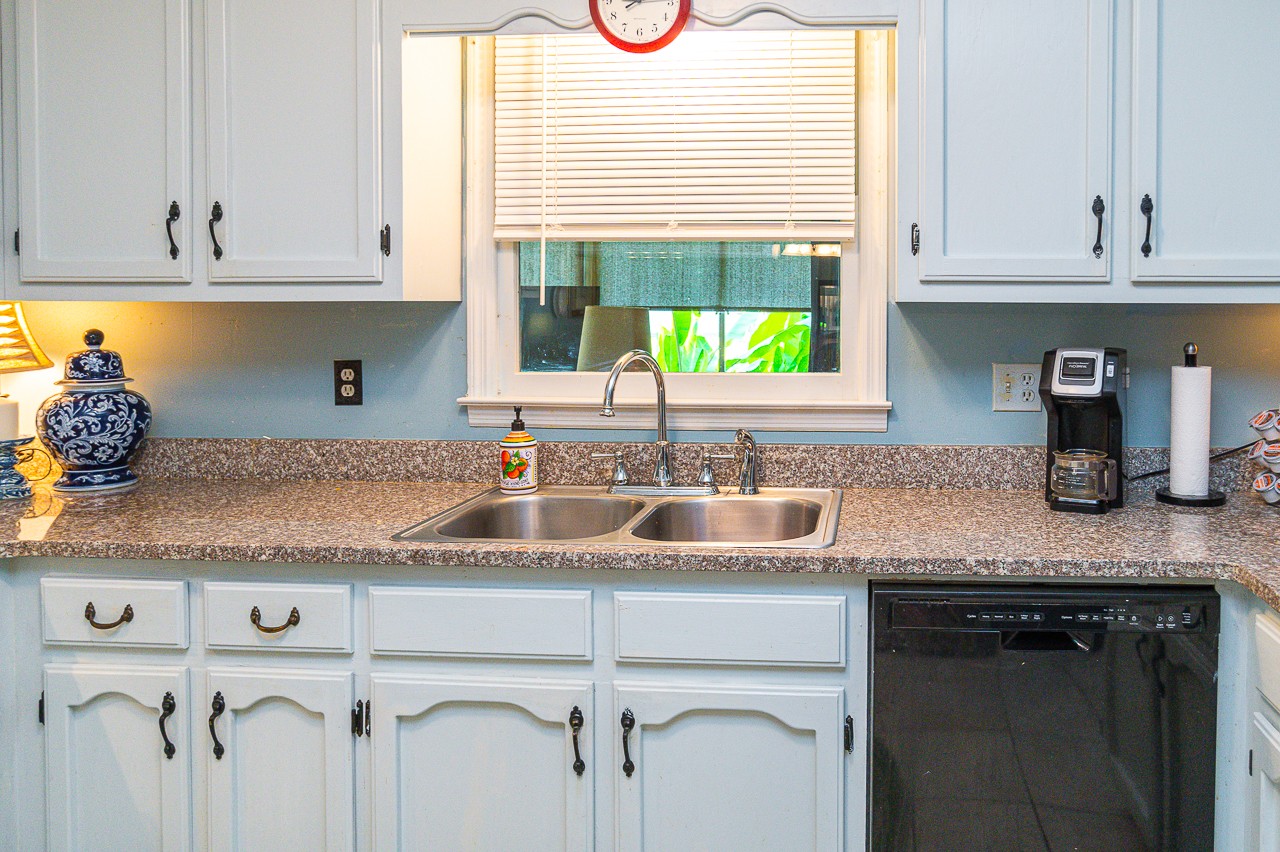 308 Jones Road Taft, TN 38488 - Photo 12 of 55 a kitchen with granite countertop a sink a window and cabinets