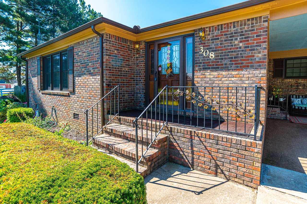 308 Jones Road Taft, TN 38488 - Photo 54 of 55 a front view of a house with a garden