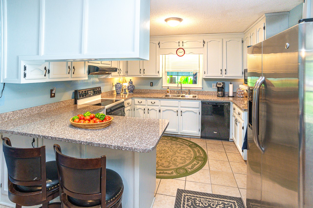 308 Jones Road Taft, TN 38488 - Photo 8 of 55 a kitchen with a sink a stove and chairs