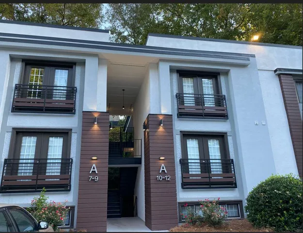 a view of a cars park in front of a building