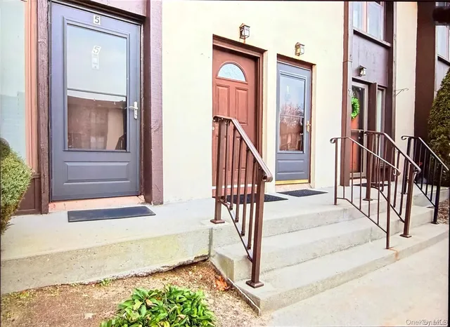 a living room with furniture a window and a book shelf