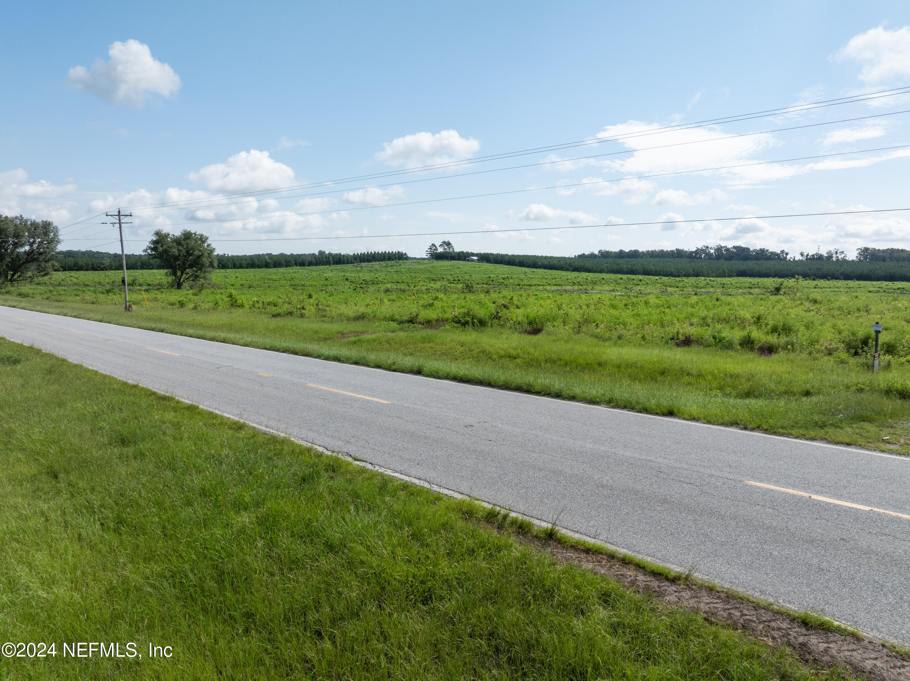 a view of a field with houses in back