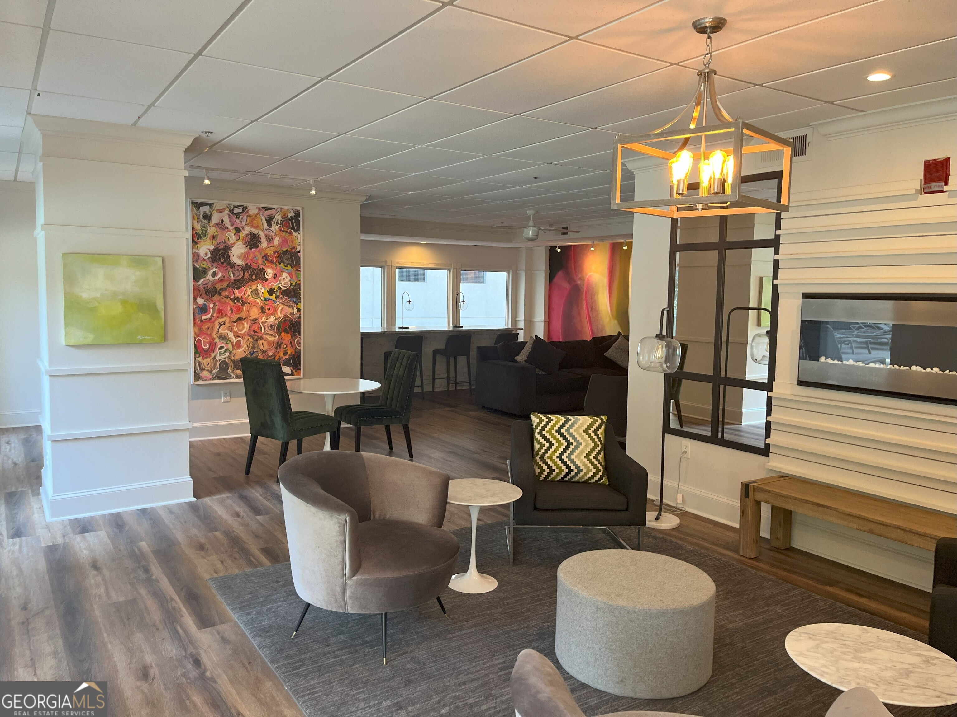 275 13th Street Northeast, Unit 605 Atlanta, GA 30309 - Photo 13 of 13 a dining room with furniture a chandelier and wooden floor