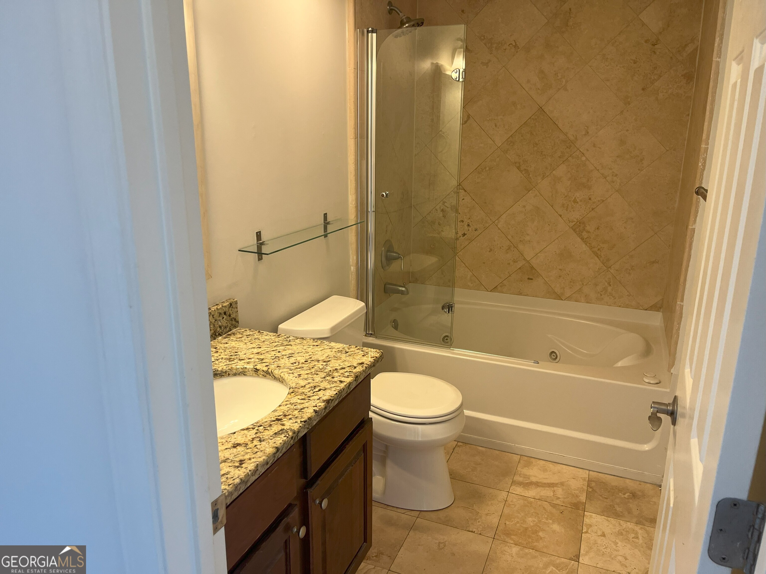 275 13th Street Northeast, Unit 605 Atlanta, GA 30309 - Photo 5 of 13 a bathroom with a granite countertop toilet and a bathtub