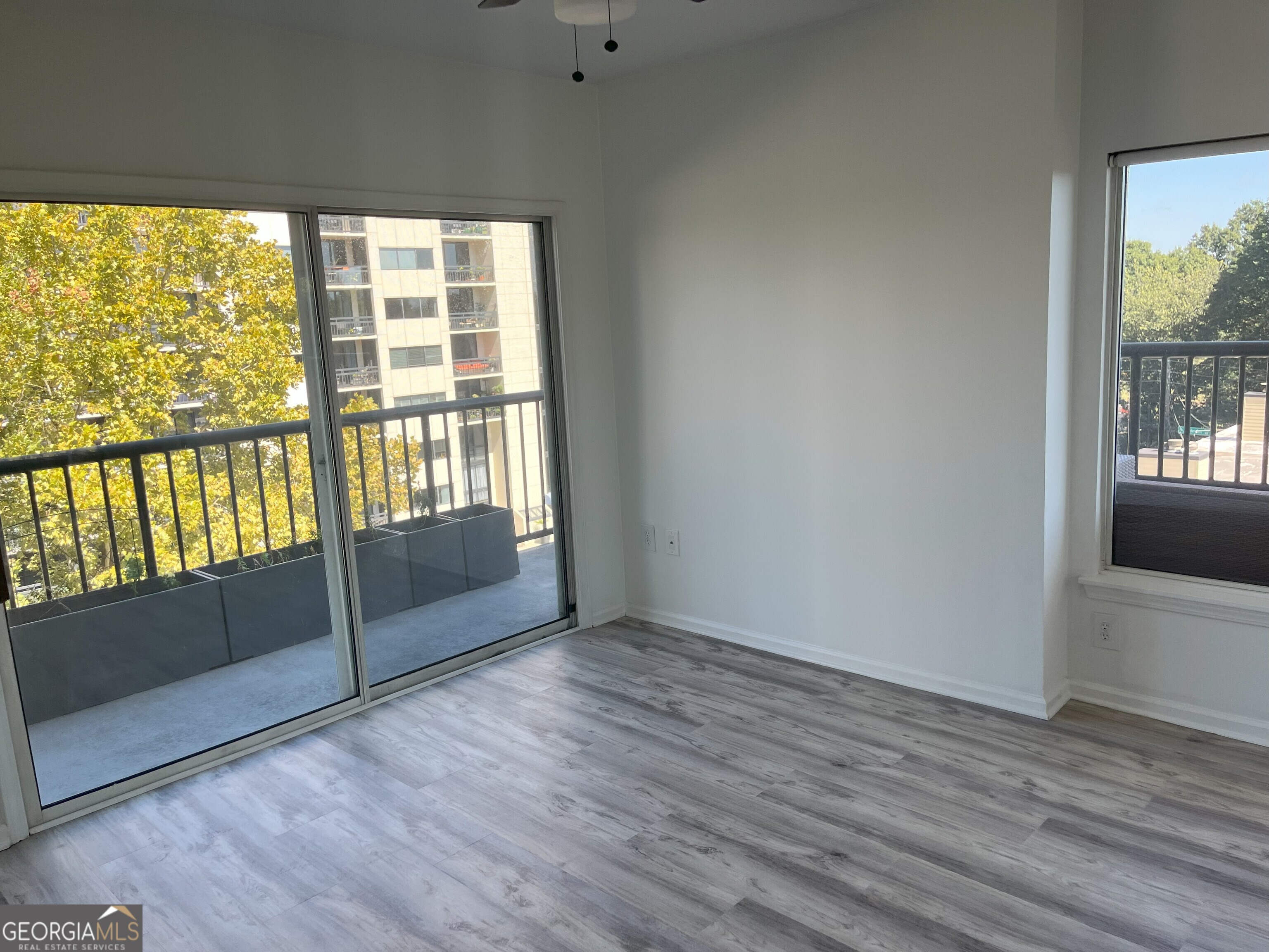 275 13th Street Northeast, Unit 605 Atlanta, GA 30309 - Photo 6 of 13 a view of an empty room with wooden floor and a window