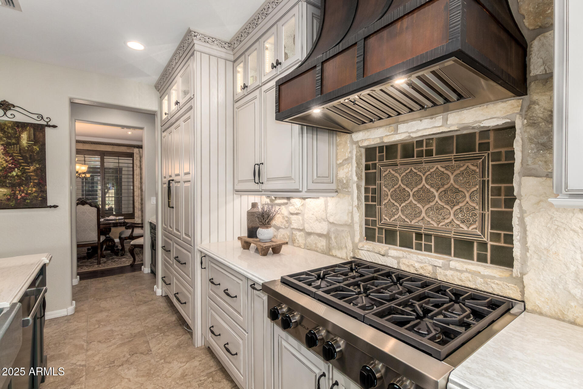 21626 North 38th Way Phoenix, AZ 85050 - Photo 9 of 72 a kitchen with wooden cabinets and a stove top oven