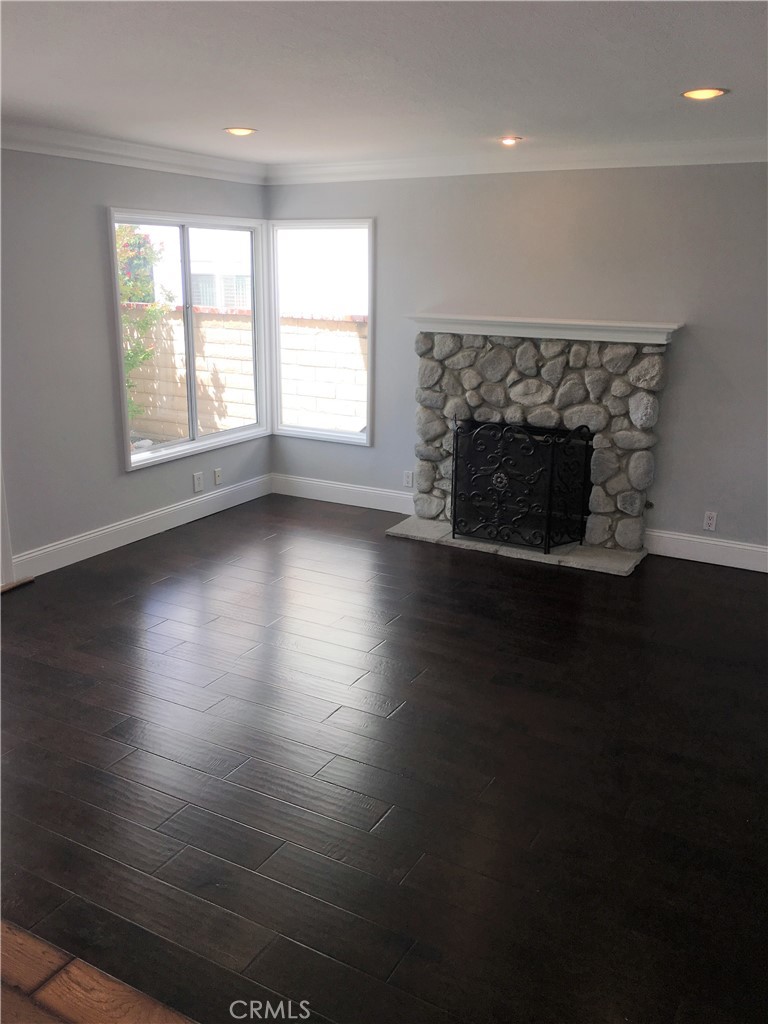 29022 Modjeska Peak Lane Lake Forest, CA 92679 - Photo 11 of 36 an empty room with wooden floor a fireplace and windows