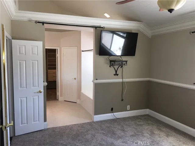 an empty room with mirror and windows